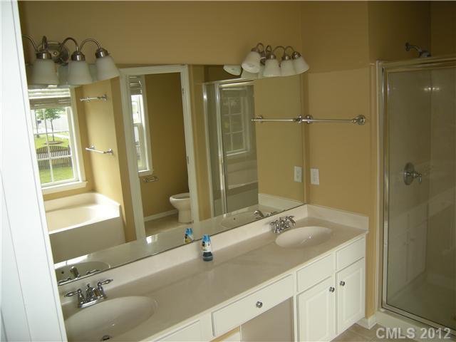 2401 Coltsgate Road, Unit 80 Waxhaw, NC 28173 - Photo 7 of 16 a bathroom with a double vanity sink and a mirror