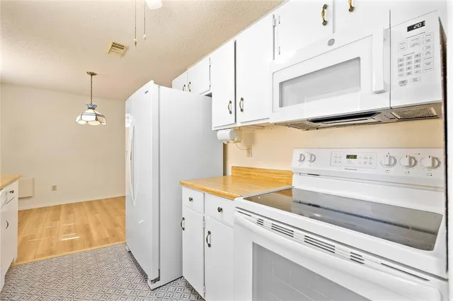 a kitchen with stainless steel appliances cabinets and a counter top space