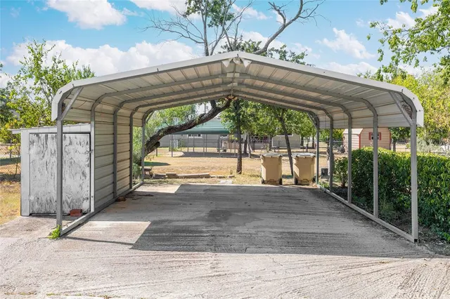 a view of entrance gate of house and car parked