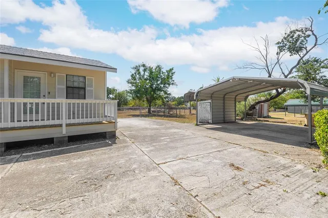 a view of a house with backyard and sitting area