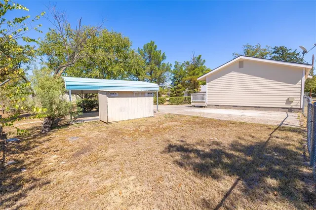 a view of a house with a yard and garage
