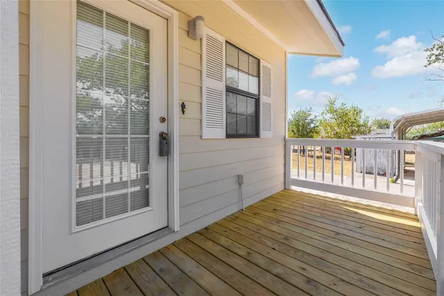 a view of a balcony with wooden floor