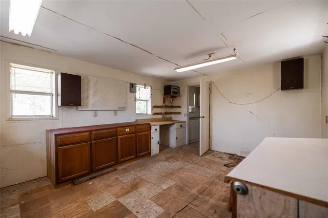 a large kitchen with a sink and counter top space