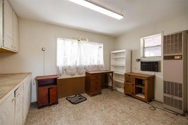 a room with furniture a flat screen tv and windows