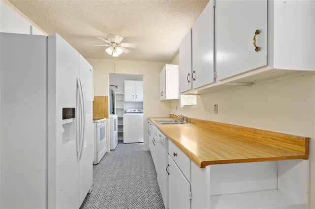 a kitchen with a refrigerator a sink and dishwasher