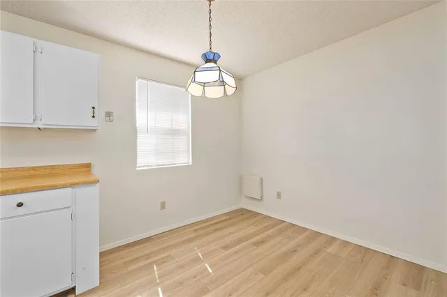 a view of a kitchen with a microwave and cabinets