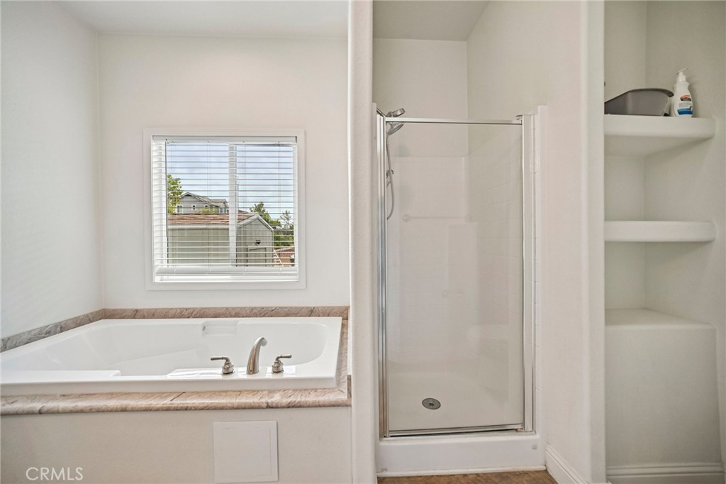 250 East Telegraph Road, Unit 307 Fillmore, CA 93015 - Photo 27 of 36 a bathroom with a granite countertop tub sink and mirror