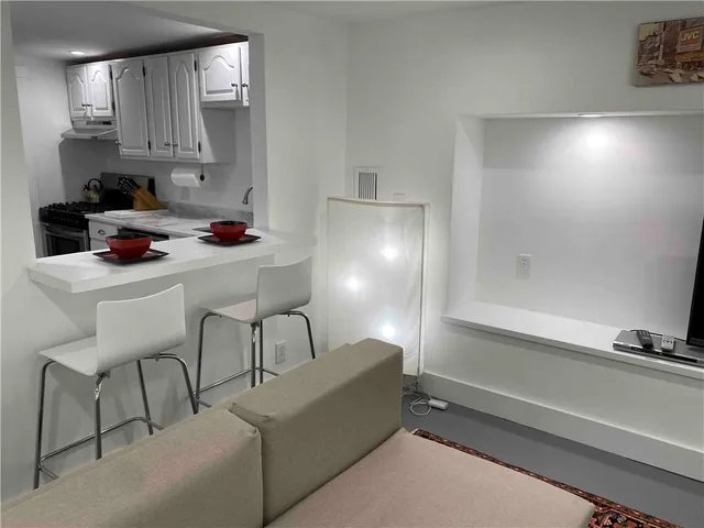 a kitchen with a sink cabinets and window