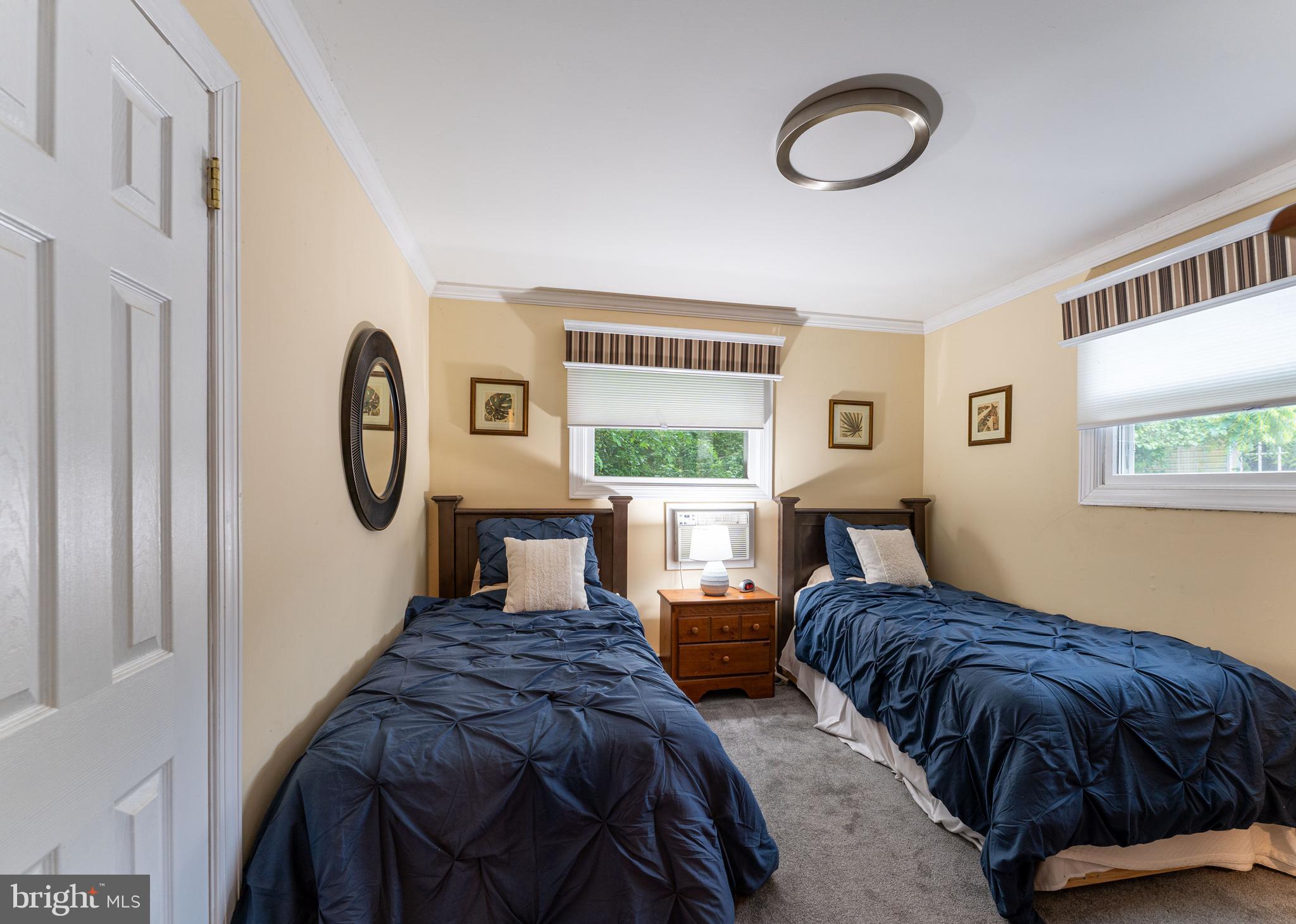 2941 Pheasant Run Road Norristown, PA 19403 - Photo 22 of 23 a bedroom with a bed a mirror and a window