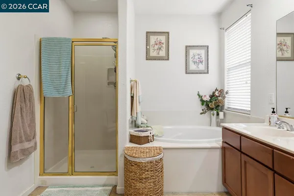 a bathroom with a sink a bathtub and a mirror