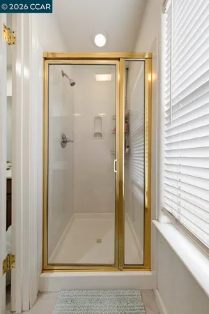 a bathroom with a glass shower door