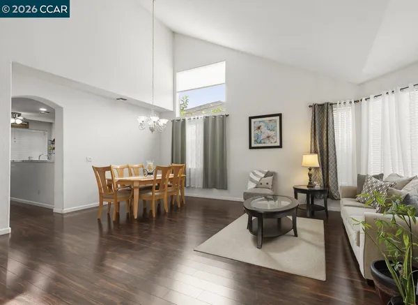 a dining room with furniture window and wooden floor