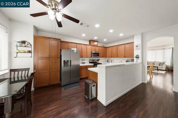 a kitchen with refrigerator cabinets and wooden floor
