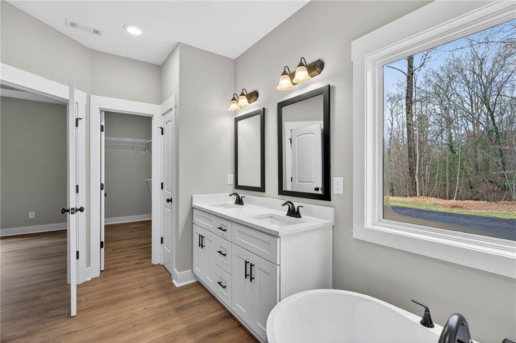 423 Relay Road Silver Creek, GA 30173 - Photo 31 of 48 a bathroom with a double vanity sink toilet mirror and window