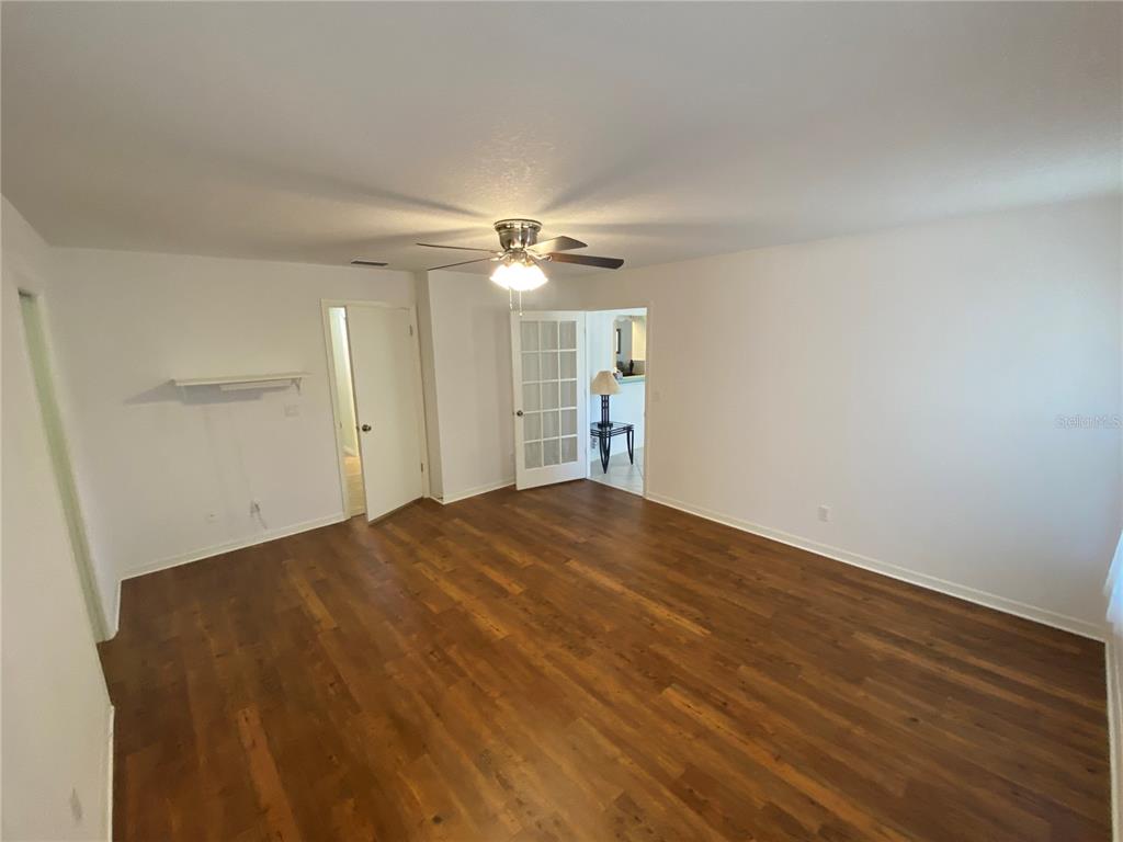 26840 Racquet Circle Leesburg, FL 34748 - Photo 11 of 19 wooden floor in an empty room