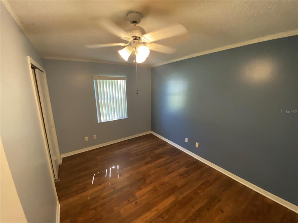 26840 Racquet Circle Leesburg, FL 34748 - Photo 13 of 19 an empty room with windows and fan