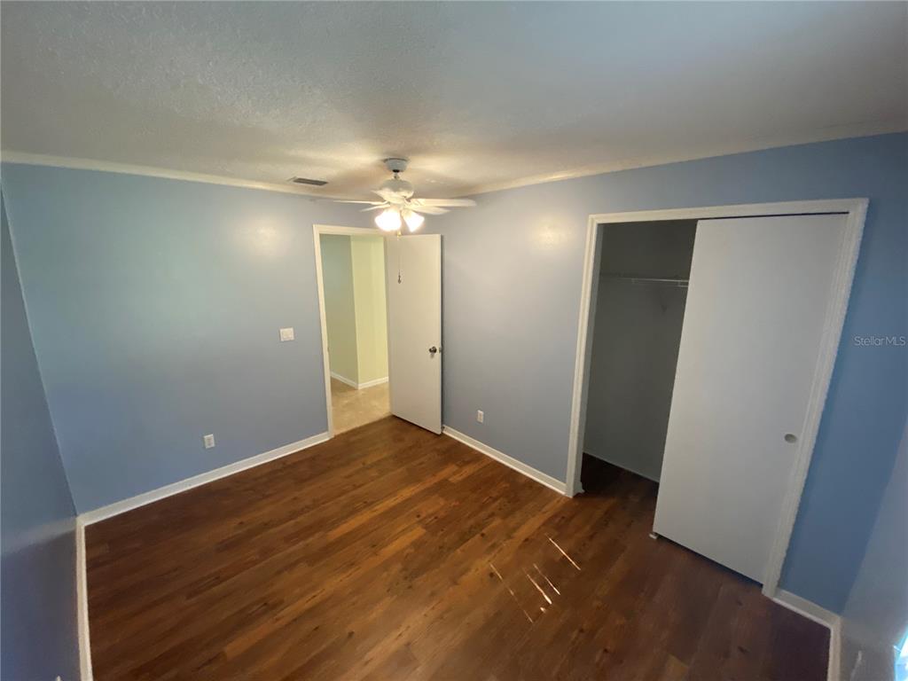26840 Racquet Circle Leesburg, FL 34748 - Photo 14 of 19 an empty room with closet and wooden floor