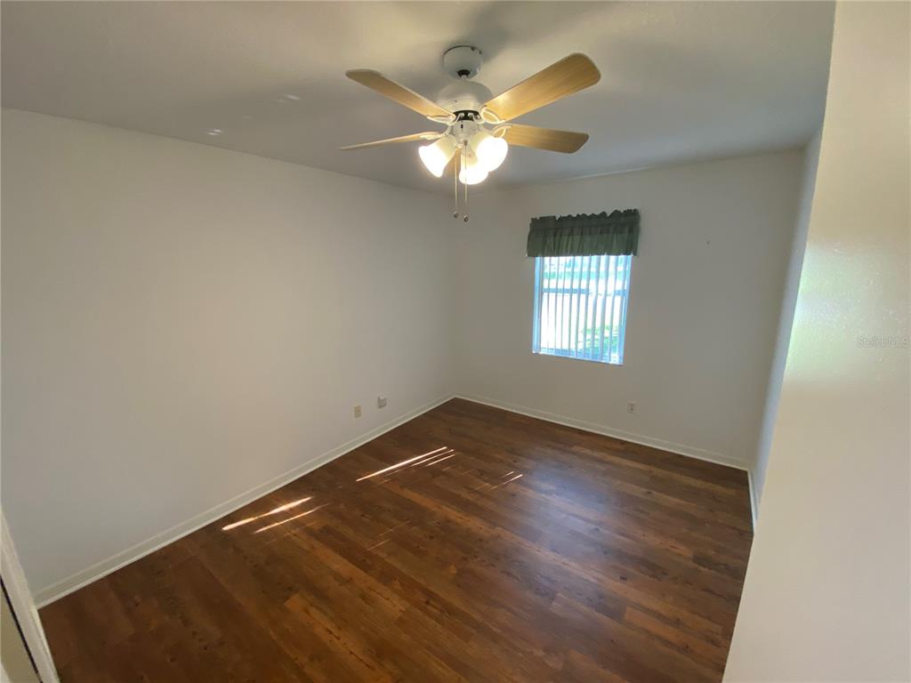 26840 Racquet Circle Leesburg, FL 34748 - Photo 15 of 19 wooden floor in an empty room with a window