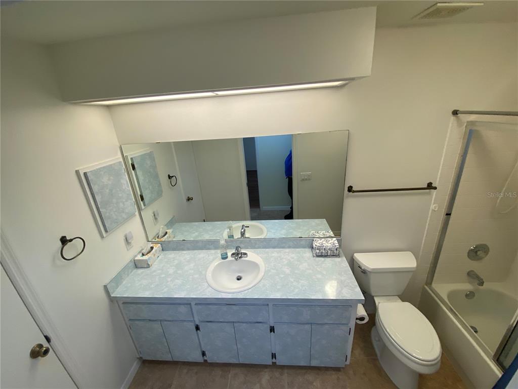 26840 Racquet Circle Leesburg, FL 34748 - Photo 16 of 19 a bathroom with a sink mirror vanity and toilet