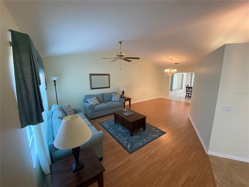 26840 Racquet Circle Leesburg, FL 34748 - Photo 4 of 19 a living room with furniture rug and a table