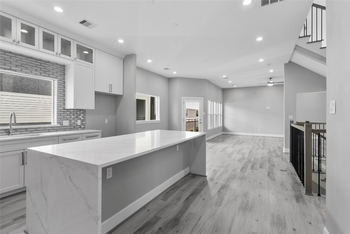 1122 West 16th Street, Unit B Houston, TX 77008 - Photo 15 of 31 a large kitchen with stainless steel appliances granite countertop a large counter top a sink a refrigerator and a stove