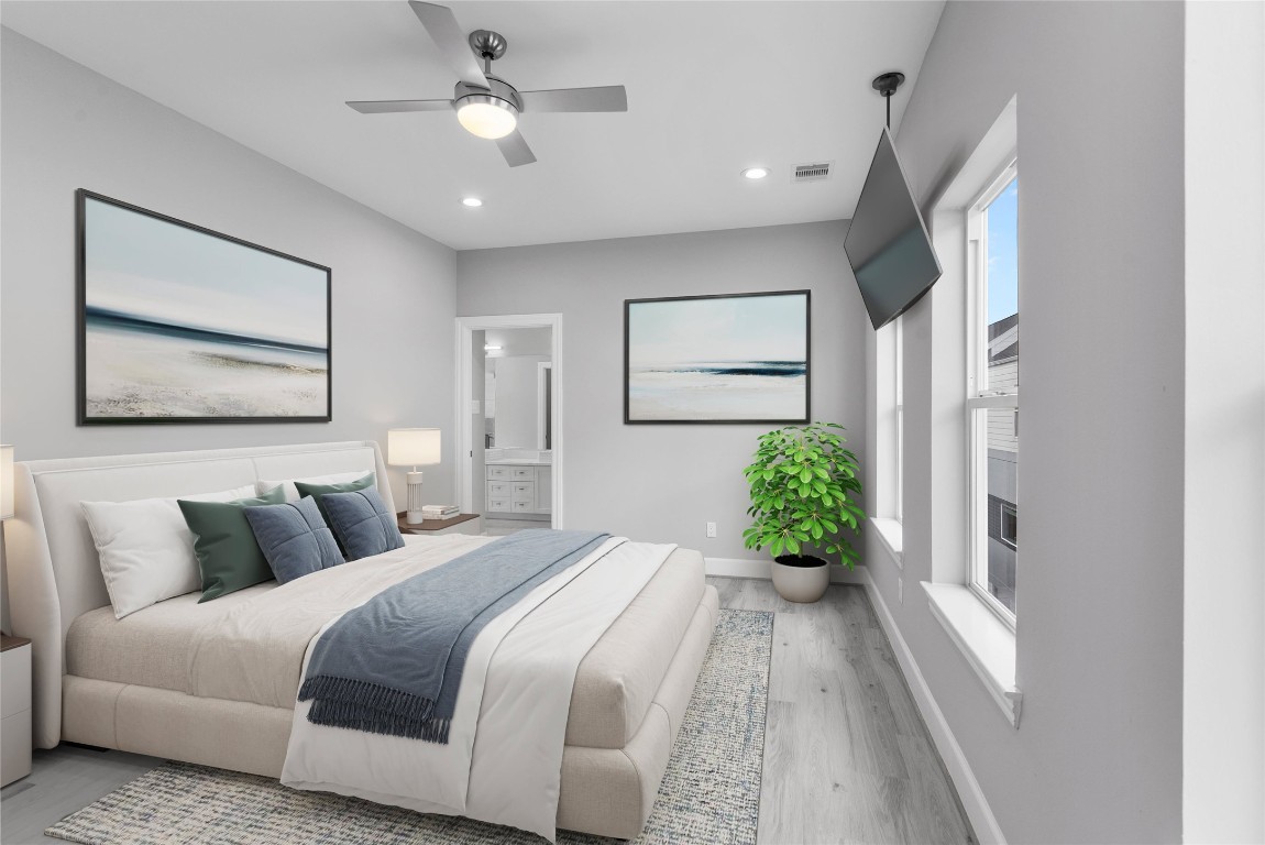 1122 West 16th Street, Unit B Houston, TX 77008 - Photo 19 of 31 a spacious bedroom with a bed and a chandelier