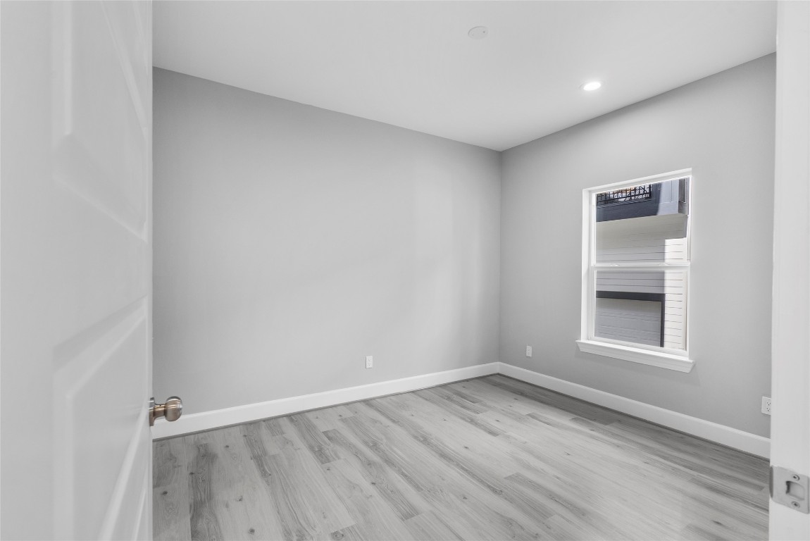 1122 West 16th Street, Unit B Houston, TX 77008 - Photo 4 of 31 an empty room with wooden floor and windows
