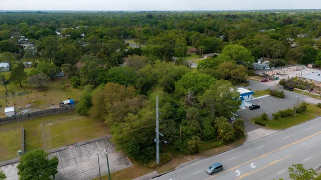 an aerial view of a houses with a yard