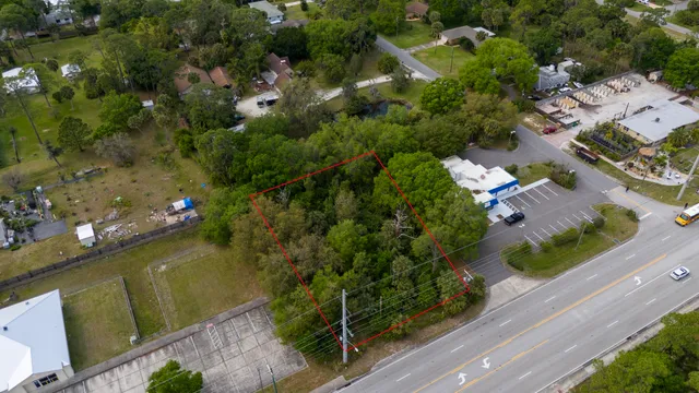 an aerial view of a house with a yard basket ball court and outdoor seating