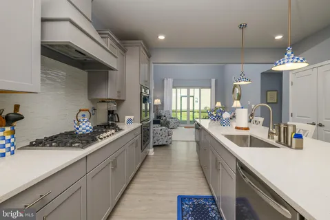 a kitchen with a sink stove and cabinets
