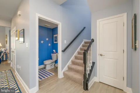 a view of a hallway with wooden floor and entryway