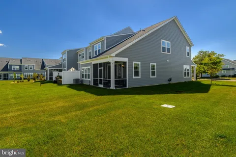 a view of a house with yard and sitting area