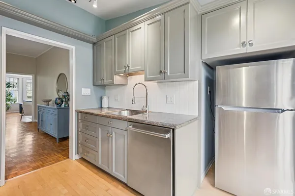 a kitchen with stainless steel appliances granite countertop a refrigerator sink and cabinets