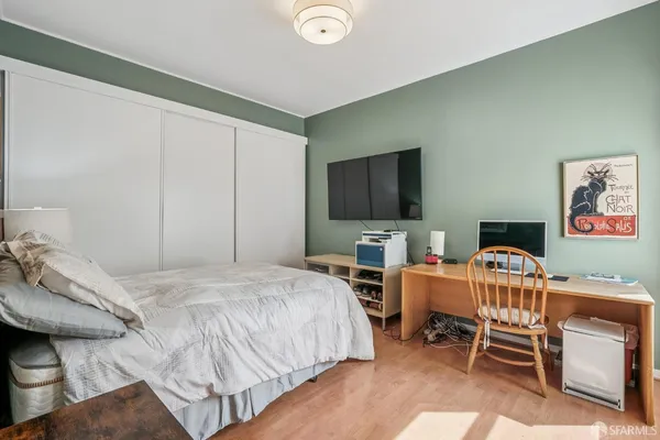a bedroom with a bed and a flat screen tv