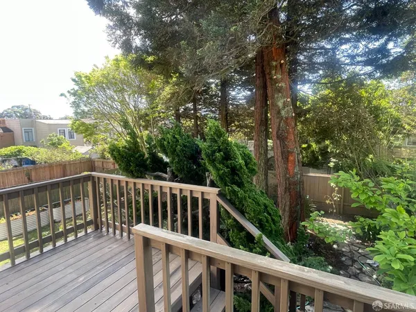 a view of balcony with deck and trees