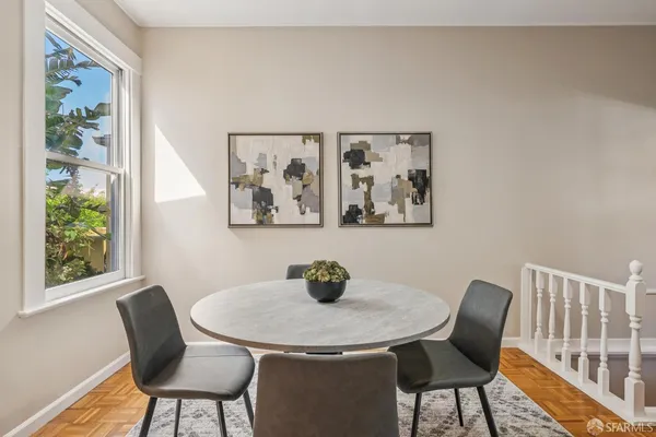 a view of a dining room with furniture and wooden floor