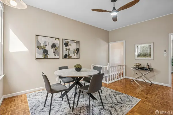 a view of a dining room with furniture and wooden floor
