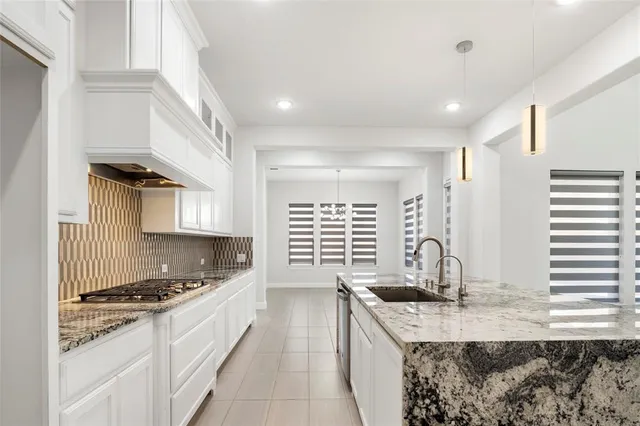 a kitchen with granite countertop a sink and a stove