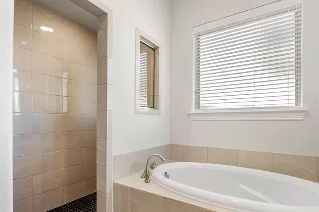 a white bath tub sitting next to a window