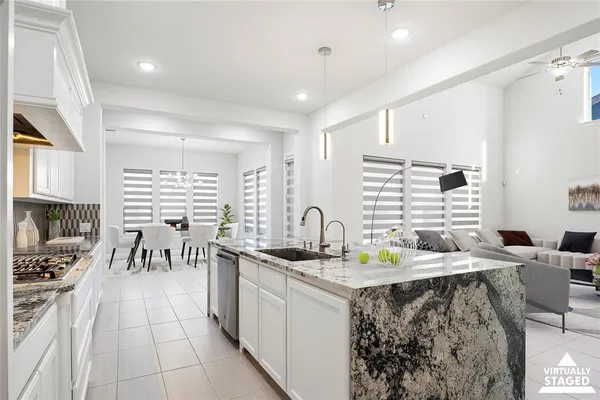 a kitchen with stainless steel appliances kitchen island granite countertop a sink and cabinets