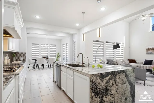 a kitchen with stainless steel appliances kitchen island granite countertop a sink and cabinets