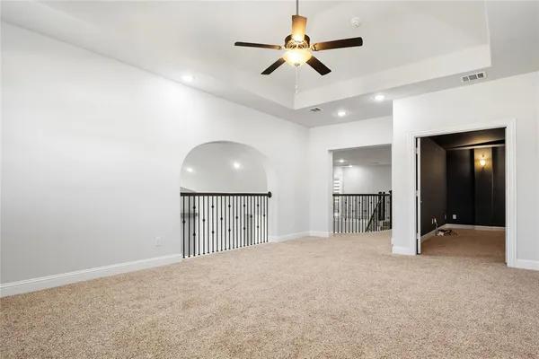 a view of empty room with ceiling fan