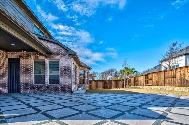 a aerial view of a house with a yard and balcony