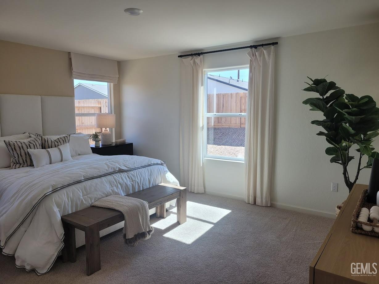 Undisclosed Address Bakersfield, CA 93307 - Photo 16 of 23 a bedroom with a bed and a potted plant