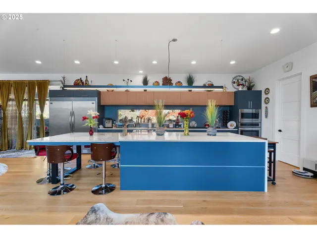 a living room with kitchen furniture and a wooden floor