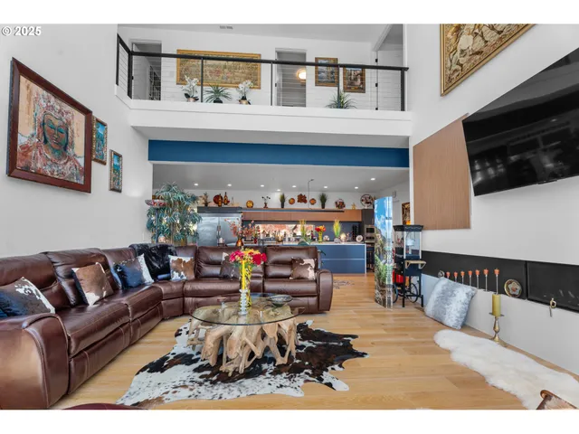 a living room with furniture a flat screen tv and a wall paintings