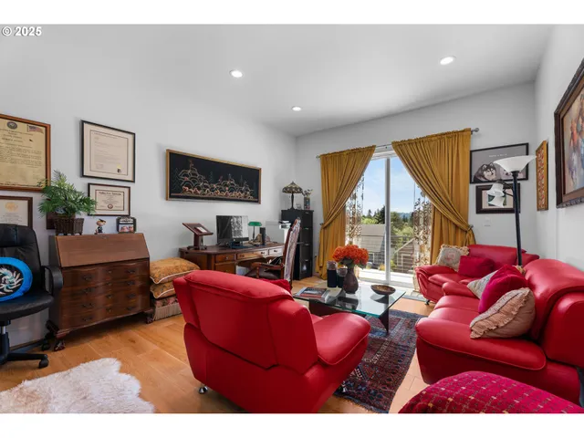 a living room with furniture a rug and a flat screen tv