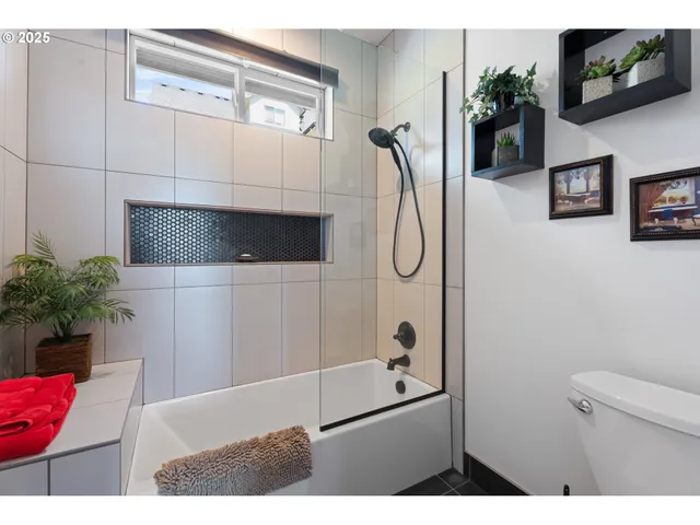 a bathroom with a shower and a mirror