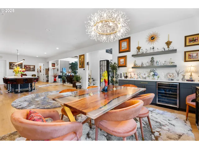 a room with stainless steel appliances kitchen island granite countertop furniture and a view of kitchen