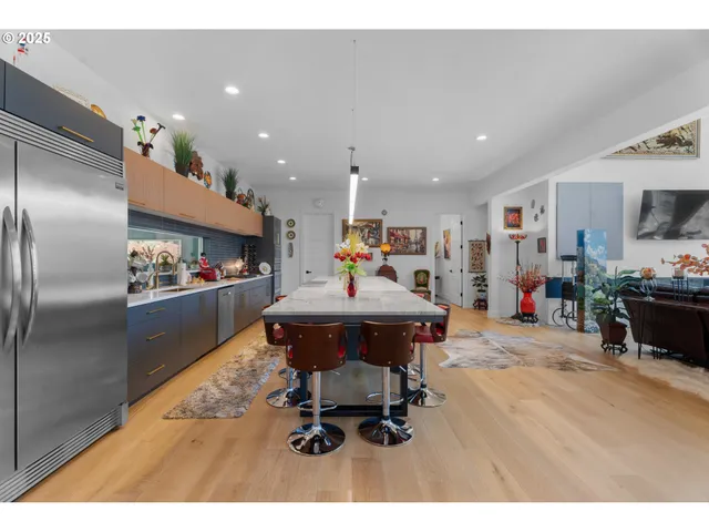 a living room with furniture and a kitchen view